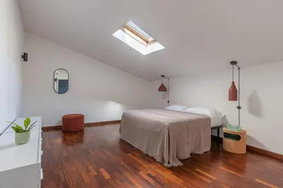a white bedroom with a bed and a skylight at Kadì Apartment by Wonderful Italy in Palermo