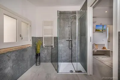 a shower with a glass door in a bathroom at VILLA AGLEA Luxury By Sicily Home Solutions in Castellammare del Golfo