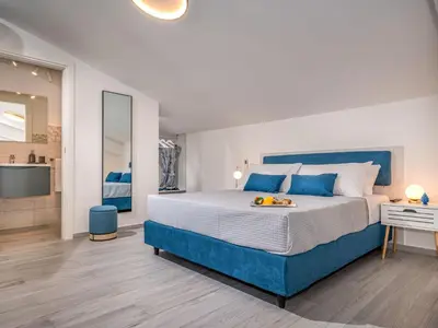 a large bedroom with a large bed and a bathroom at Apartment Attico Dolce Vista by Interhome in Castellammare del Golfo