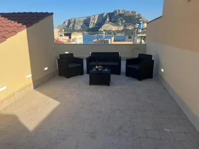 a balcony with chairs and a table with a view at GFL Mondello - Appartamenti vista mare in Mondello