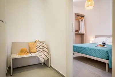 a small bedroom with a bed and a table at Villa Hemèra Luxury By Sicily Home Solutions in Castellammare del Golfo
