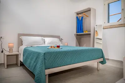 a bedroom with a bed with a tray of food on it at Villa Hemèra Luxury By Sicily Home Solutions in Castellammare del Golfo