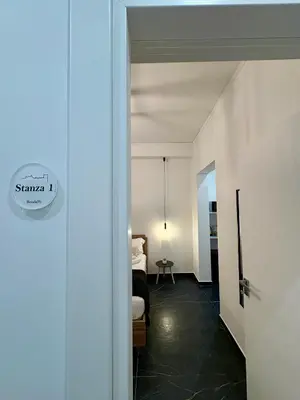 an open door to a bedroom with a bed in a room at Renda36 in Carini