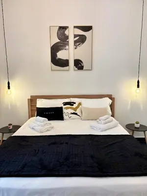 a bedroom with a large bed with two tables at Renda36 in Carini