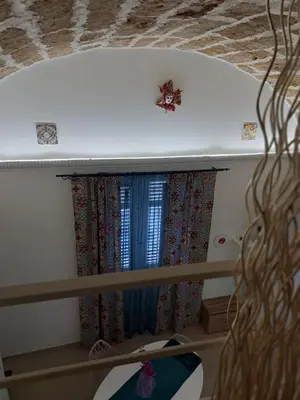a bunk bed with two windows in a room at Relaxing Room in Terrasini