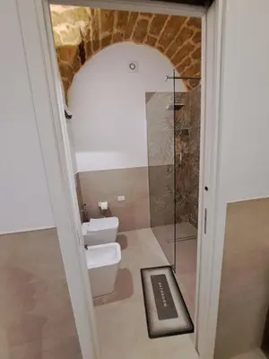 a bathroom with a toilet and a glass shower at Relaxing Room in Terrasini