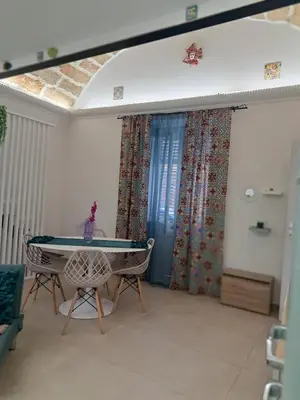 a room with a ping pong table and chairs at Relaxing Room in Terrasini