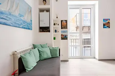 a living room with a couch in front of a door at Casa Bellini in Palermo