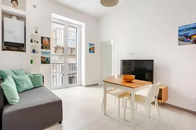a living room with a table and a couch at Casa Bellini in Palermo