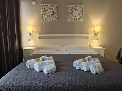 a bedroom with a bed with towels on it at Hostel Josef in Palermo