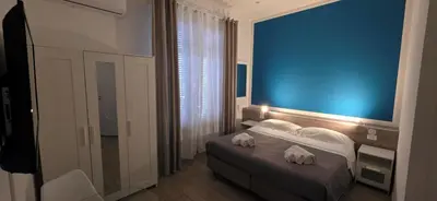 a hotel room with a bed with towels on it at Hostel Josef in Palermo