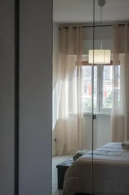 a bedroom with a large white bed in a room at Casa Antonio in Palermo