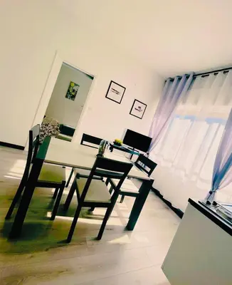 a desk with chairs and a laptop on it in a room at Florio Suite Apartment in Palermo