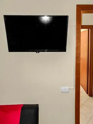 a flat screen tv hanging on a wall at Onda Blu Apartment in Balestrate