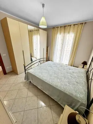 a bedroom with a large bed in front of a window at Onda Blu Apartment in Balestrate