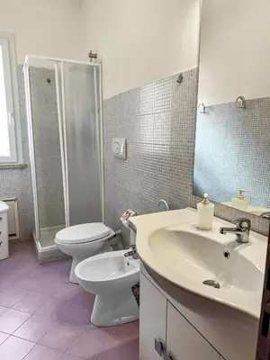 a bathroom with a sink and a toilet and a shower at Onda Blu Apartment in Balestrate