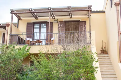 a house with a balcony with chairs on it at euforbia in San Vito lo Capo