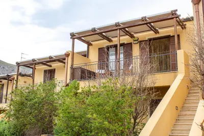 a house with a balcony and stairs at euforbia in San Vito lo Capo