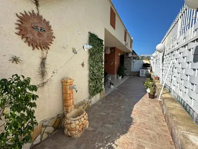 a building with a sun mural on the side of it at La Perla Di Campofelice in Campofelice di Roccella