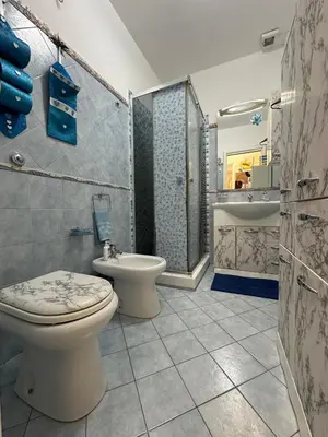 a bathroom with a toilet and a sink and a tub at La Perla Di Campofelice in Campofelice di Roccella