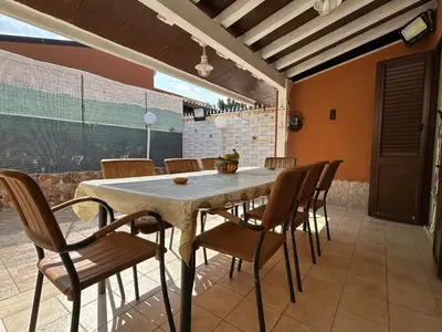 a dining room with a table and chairs at La Perla Di Campofelice in Campofelice di Roccella