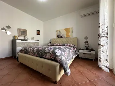 a bedroom with a bed and a dresser at La Perla Di Campofelice in Campofelice di Roccella