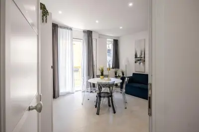 a living room with a table and a blue couch at Dream Holidays - Apartments in Palermo