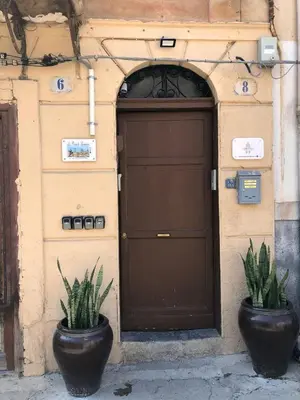 two potted plants sitting in front of a garage at La Piccola Formica in Palermo