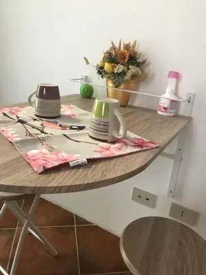 a table with plates and cups on top of it at Nonno Antonio's House in Palermo