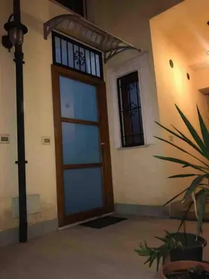 a front door of a house with a potted plant at Nonno Antonio's House in Palermo