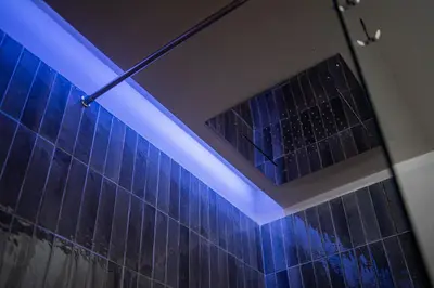 a blue light in a bathroom with a shower at Dimora Ballarò in Palermo