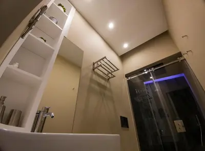 a bathroom with a sink and a shower with a mirror at Dimora Ballarò in Palermo