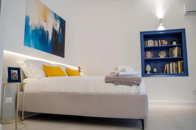 a room with a bed and a book shelf at Dimora Ballarò in Palermo