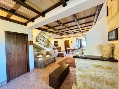 a large living room with a staircase and a couch at Villa Bellavista in Carini