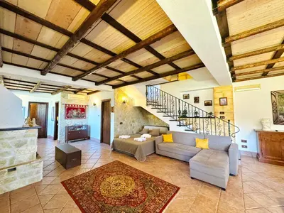 a living room with a couch and a staircase at Villa Bellavista in Carini