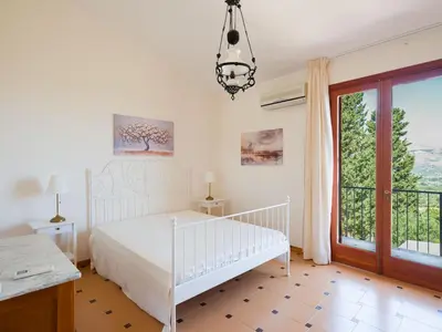 a bedroom with a white bed and a window at Villa Hybiscus con piscina in Castellammare del Golfo
