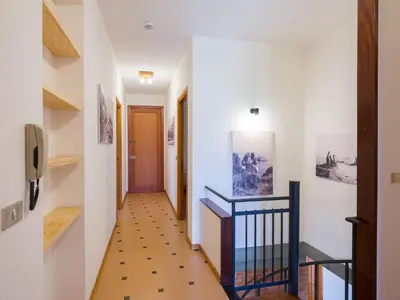 a hallway with white walls and wooden floors and a staircase at Villa Hybiscus con piscina in Castellammare del Golfo