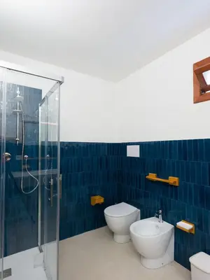 a bathroom with a shower and a toilet and a sink at Villa Hybiscus con piscina in Castellammare del Golfo