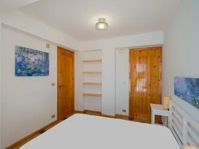 a bedroom with a white bed and a tv at Villa Hybiscus con piscina in Castellammare del Golfo
