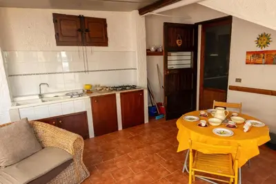 a living room with a table with a yellow table cloth at Baia Marina Oasi in Balestrate