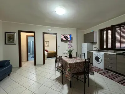 a kitchen and dining room with a table and chairs at Maribu in Casteldaccia