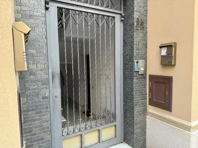 a metal gate on the side of a building at Maribu in Casteldaccia