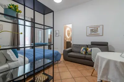 a living room with a couch and a glass shelf at GuestHost - Casetta del Romito - Lovely Studios in Palermo