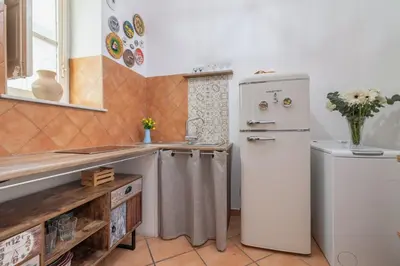 a kitchen with a refrigerator and a sink at GuestHost - Casetta del Romito - Lovely Studios in Palermo