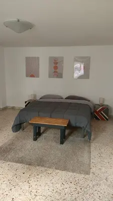a bedroom with a bed and a wooden table at Mak house in Palermo