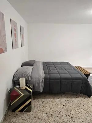 a bedroom with a bed and a side table at Mak house in Palermo