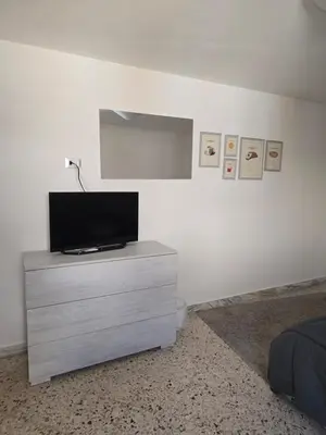 a bedroom with a tv on a dresser in a room at Mak house in Palermo