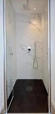 a bathroom with a shower with a glass door at Palazzo Gregorietti Boutique Apartments in Palermo