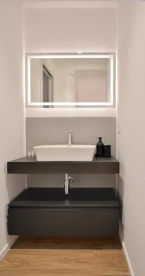 a bathroom with a sink and a mirror at Palazzo Gregorietti Boutique Apartments in Palermo