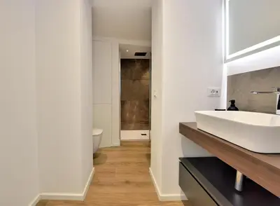 a bathroom with a white sink and a toilet at Palazzo Gregorietti Boutique Apartments in Palermo
